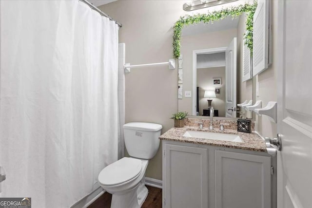 bathroom with a shower with shower curtain, wood-type flooring, vanity, and toilet