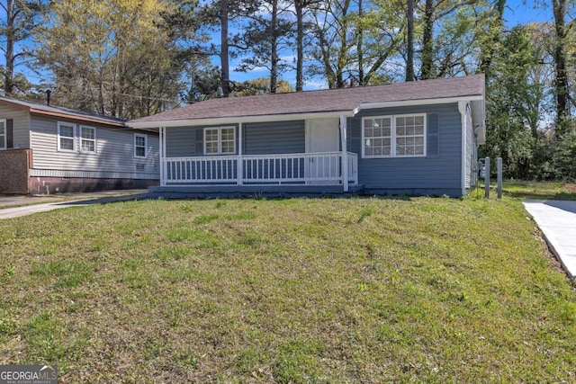 single story home featuring covered porch and a front yard