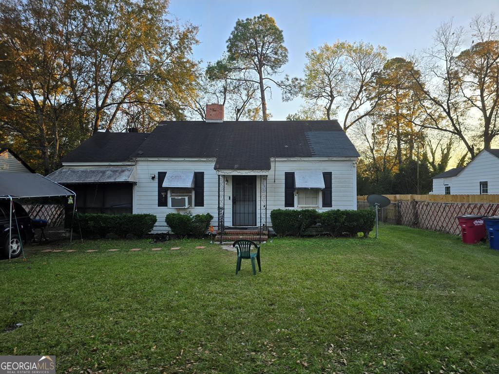 view of front of house featuring a front lawn and cooling unit