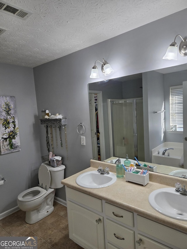 full bathroom with vanity, tile patterned floors, toilet, a textured ceiling, and independent shower and bath