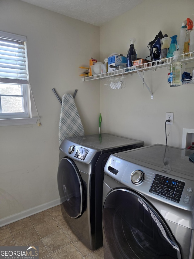 laundry room featuring washer and dryer and a textured ceiling