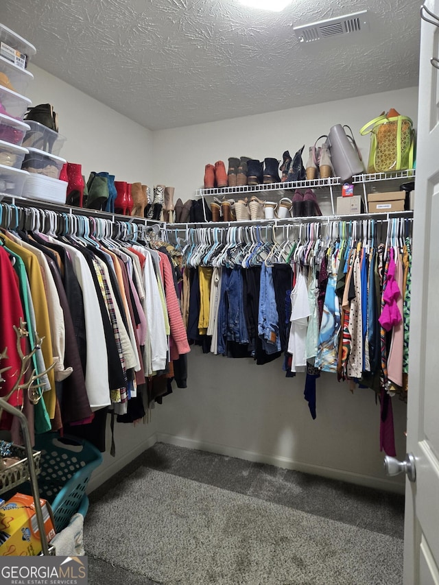 walk in closet featuring carpet