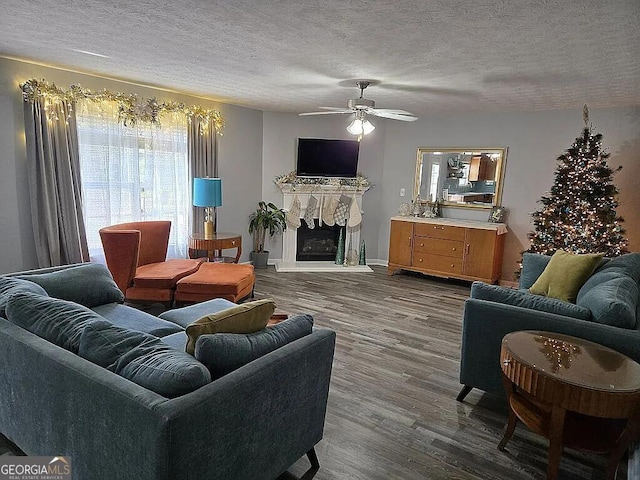 living room featuring a textured ceiling, ceiling fan, and dark hardwood / wood-style floors