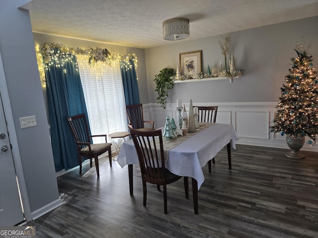 dining area with dark hardwood / wood-style floors and a textured ceiling