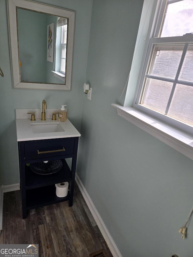 bathroom with vanity and hardwood / wood-style flooring