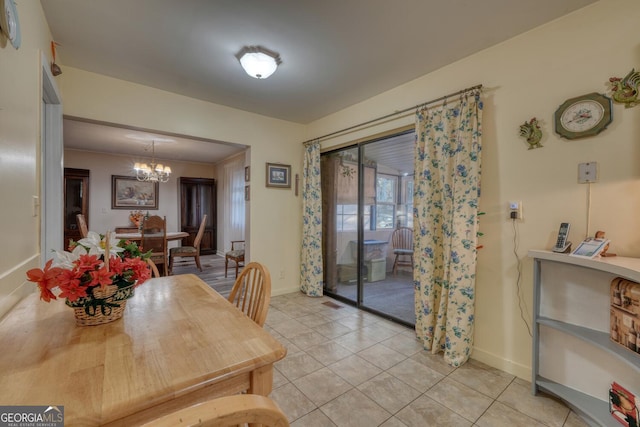 tiled dining space with a notable chandelier