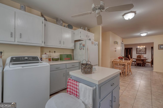 kitchen featuring gray cabinetry, ceiling fan with notable chandelier, white refrigerator, light tile patterned floors, and washer / clothes dryer