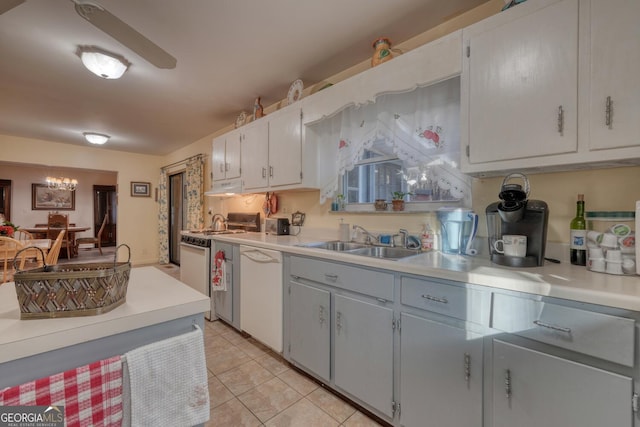 kitchen with white cabinets, light tile patterned floors, white appliances, and sink