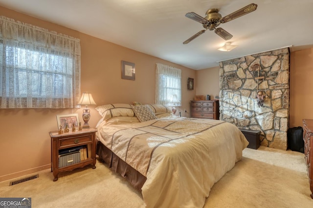 bedroom featuring light carpet and ceiling fan