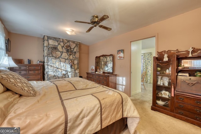 bedroom featuring ceiling fan and light carpet