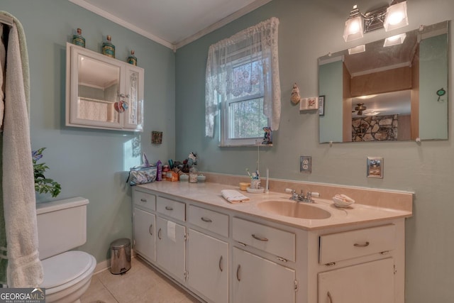 bathroom featuring tile patterned flooring, vanity, toilet, and crown molding