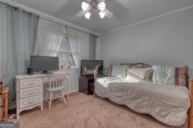 carpeted bedroom featuring ceiling fan and crown molding