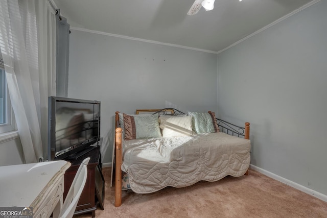 bedroom with carpet flooring, ceiling fan, and crown molding