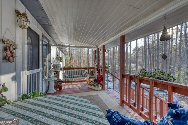 sunroom / solarium featuring wood ceiling