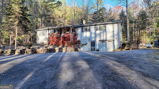 exterior space featuring a garage and a deck