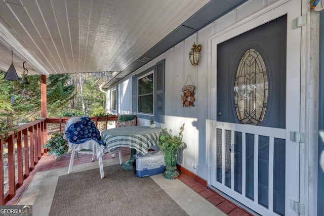 view of exterior entry with covered porch