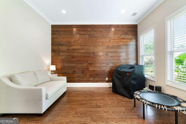 sitting room featuring wood-type flooring and ornamental molding