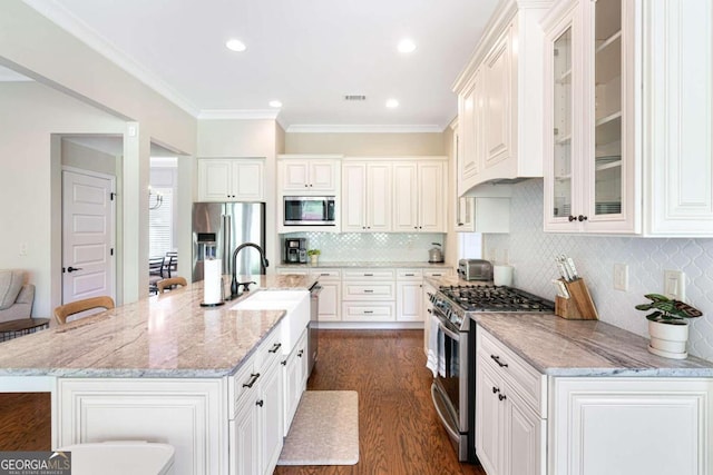 kitchen featuring white cabinets, a breakfast bar, and stainless steel appliances