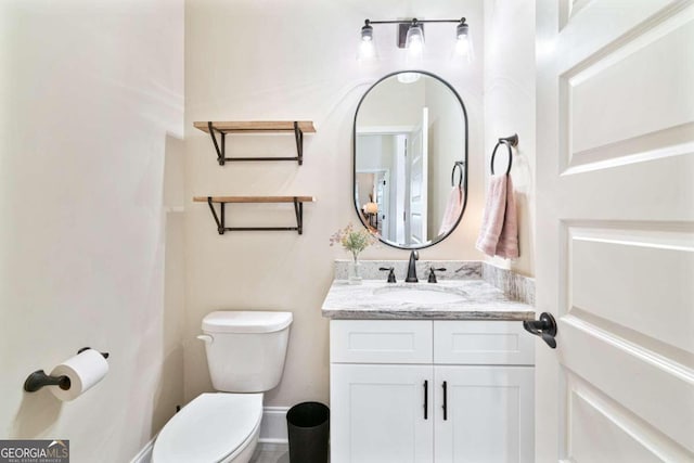 bathroom featuring vanity and toilet