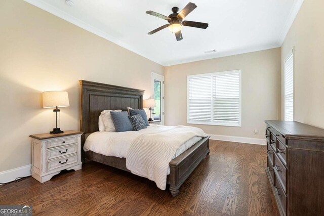 bedroom featuring ceiling fan, crown molding, and dark hardwood / wood-style floors