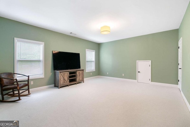 living room with plenty of natural light and carpet