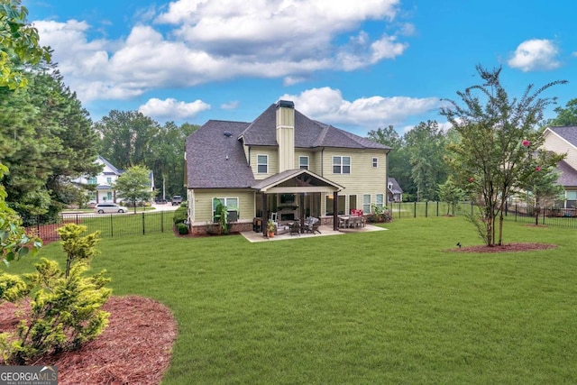 rear view of house with a patio area and a yard