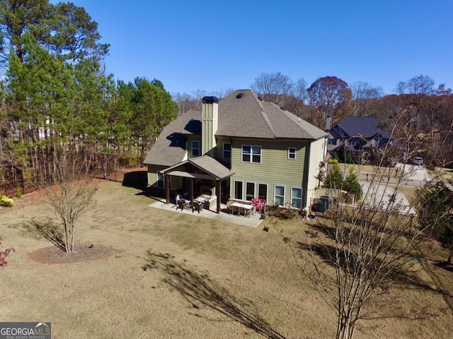 back of house with a patio