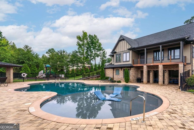 view of swimming pool with a patio