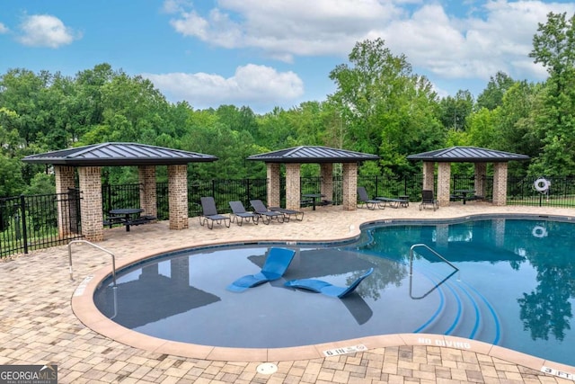 view of swimming pool with a gazebo and a patio area