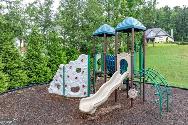 view of playground with a lawn