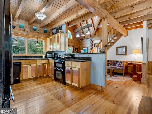 kitchen with wood walls, wooden ceiling, black appliances, vaulted ceiling with beams, and light wood-type flooring