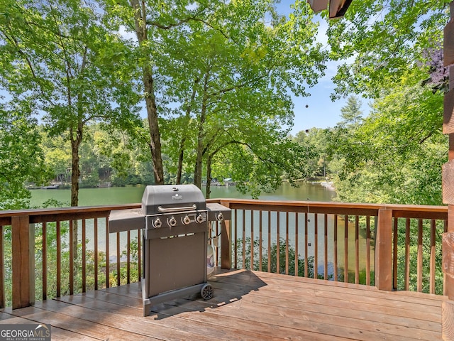 wooden deck featuring a water view and grilling area