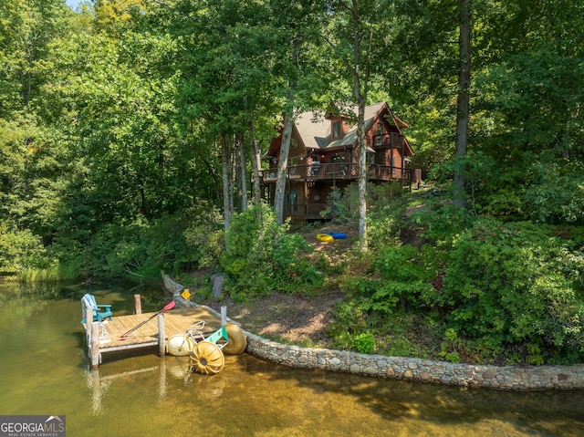 exterior space featuring a water view and a dock