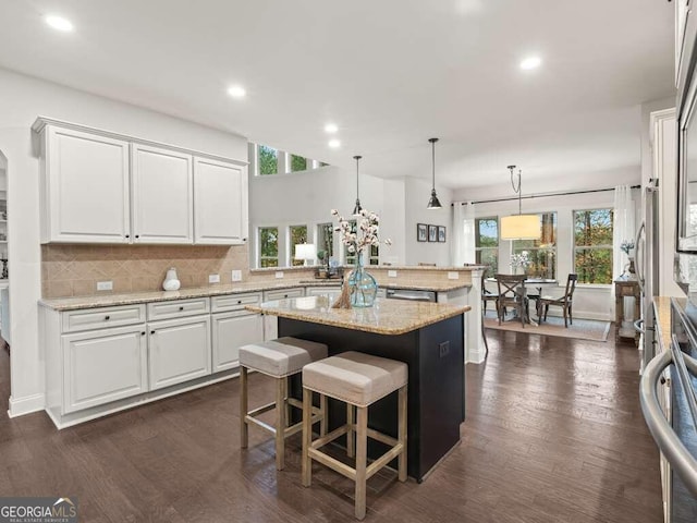 kitchen with white cabinetry, a center island, and plenty of natural light