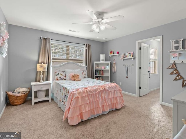 bedroom featuring light carpet and ceiling fan