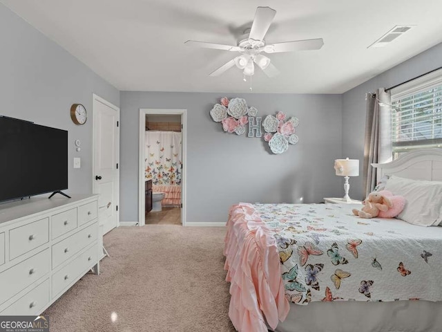 carpeted bedroom with ceiling fan and ensuite bathroom