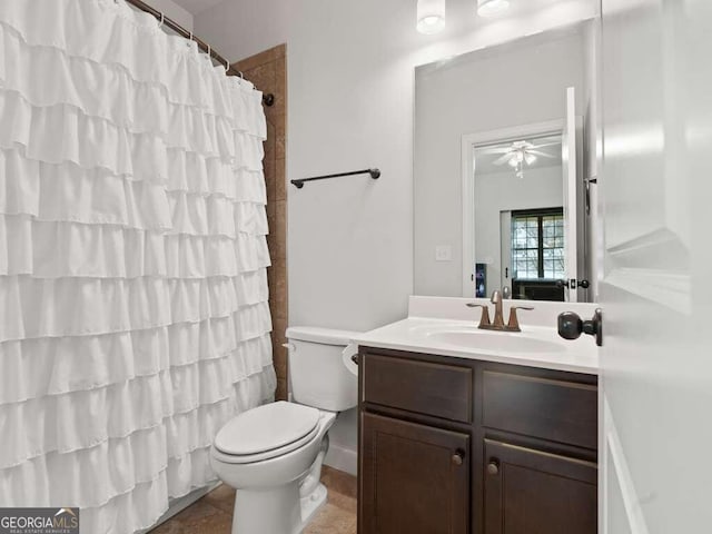 bathroom featuring ceiling fan, tile patterned floors, toilet, vanity, and a shower with shower curtain