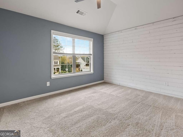 unfurnished room featuring light colored carpet, ceiling fan, and lofted ceiling