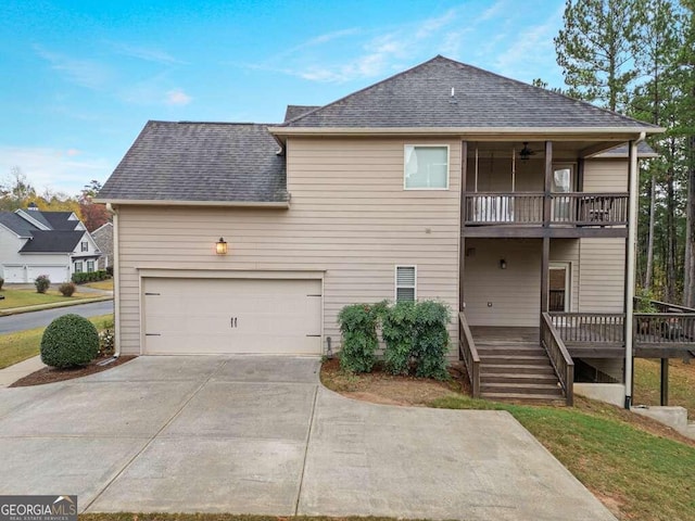 rear view of house with a balcony and a garage