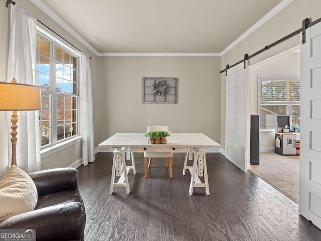 office area with a barn door, dark hardwood / wood-style flooring, and ornamental molding