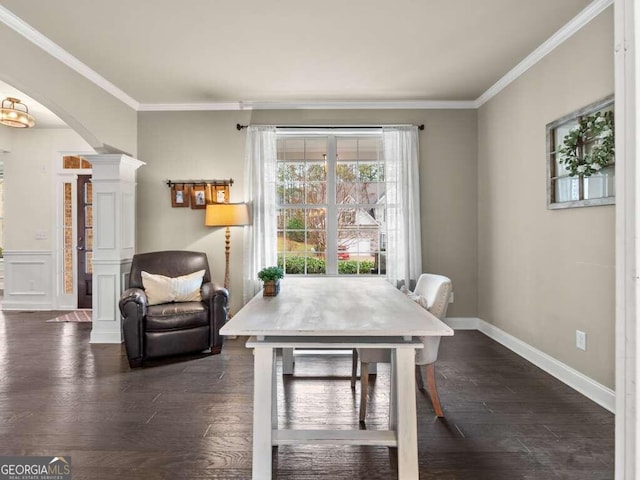 dining room with ornate columns, dark hardwood / wood-style flooring, and ornamental molding