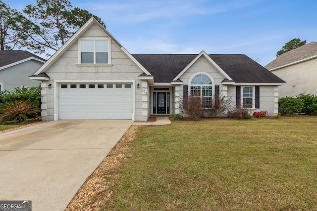 view of front of house featuring a front lawn and a garage