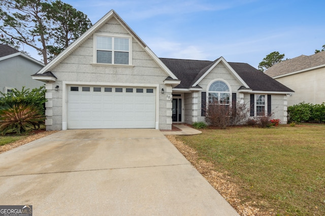 view of front facade with a front lawn and a garage