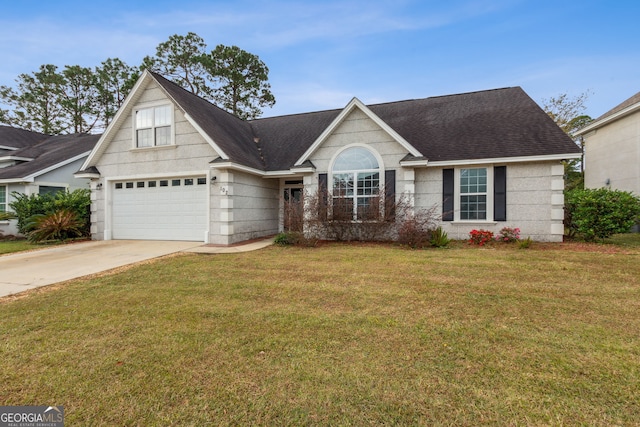 view of front of property with a front yard and a garage