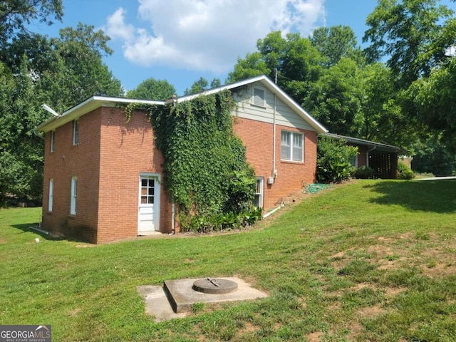 view of side of property featuring a yard