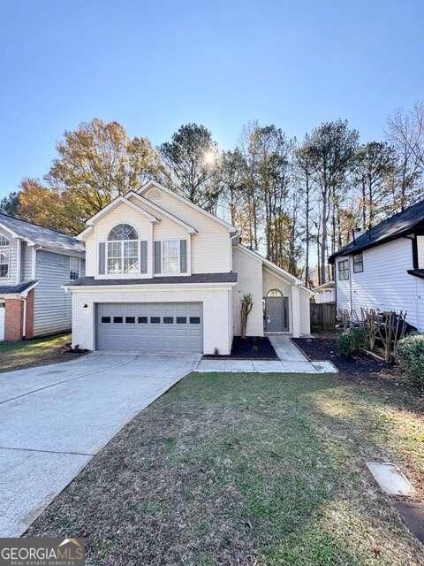 view of front property featuring a front yard and a garage