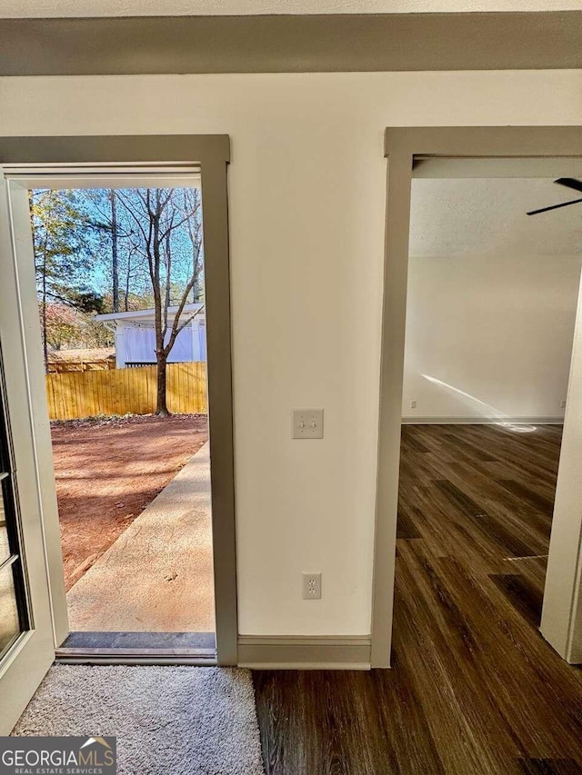 doorway to outside featuring ceiling fan and wood-type flooring