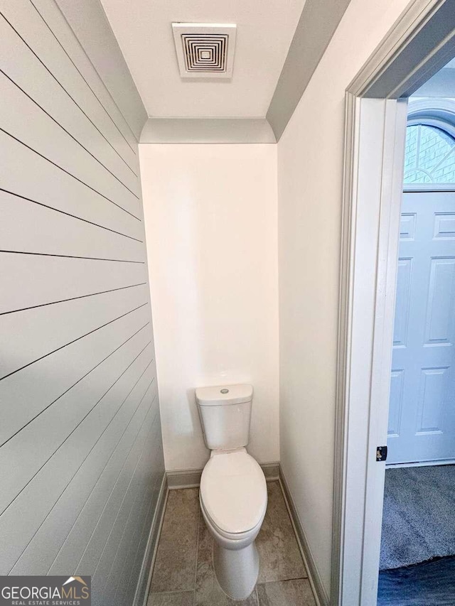 bathroom with tile patterned flooring and toilet