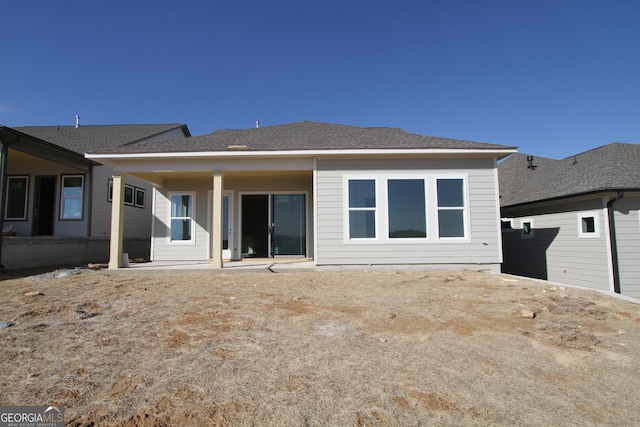 back of property with a patio