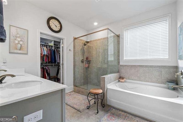 bathroom with separate shower and tub and vanity